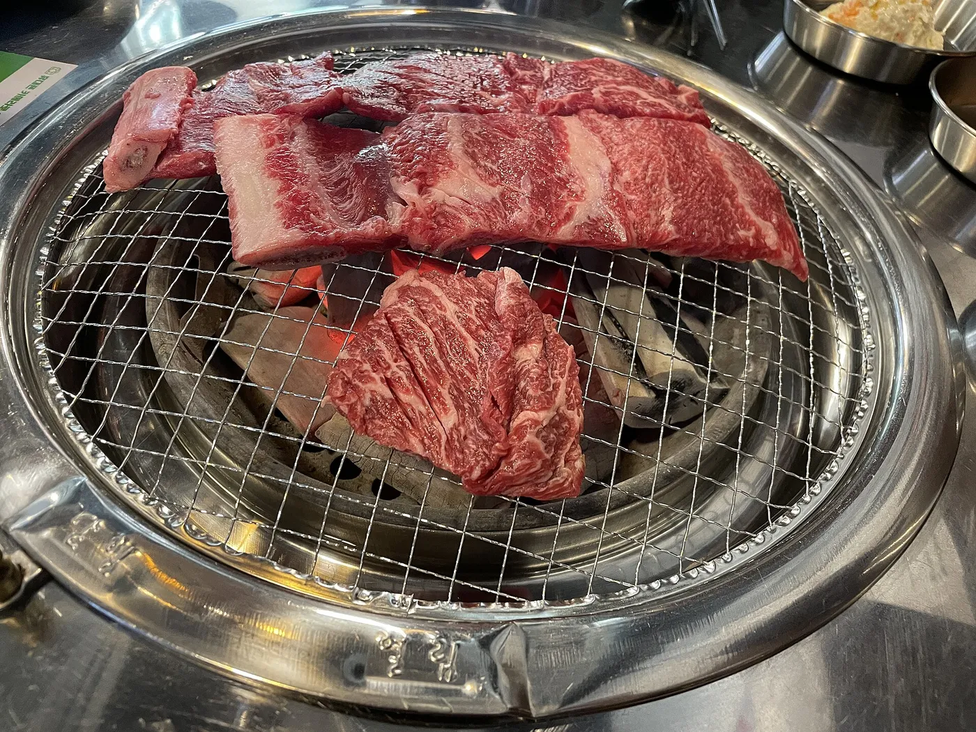 Food cooking on a tabletop Korean barbecue grill